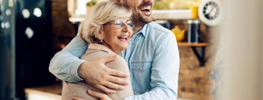 Sue and her son celebrating her reverse mortgage